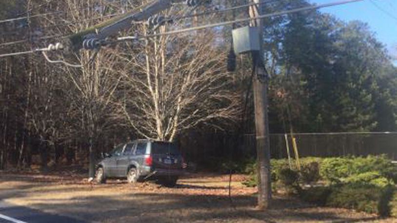 Old Norcross Road in Lawrenceville in Gwinnett County was expected to be closed until 5 or 7 p.m. Saturday after a car slid on ice and a powerline fell.
