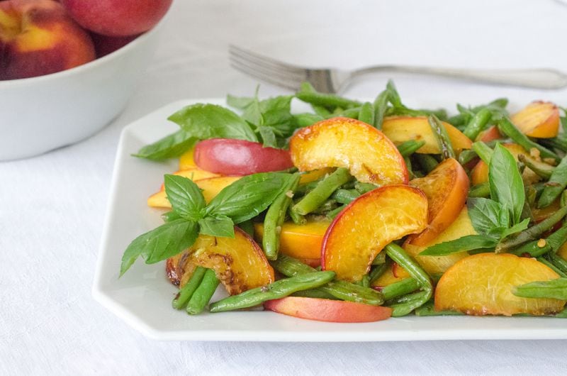 Get in and out of a hot kitchen with quick and easy peach recipes bold with summer flavor and light on the fat. The delightful combination of green beans and buttery peaches is sure to please. (Virginia Willis for The Atlanta Journal-Constitution)
