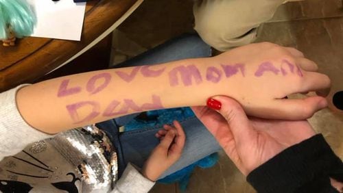 During a lockdown at a Delaware school in which she hid behind a bookshelf, a 7-year-old wrote a farewell message to her parents in purple marker on her arm in case she died – “Love mom and dad.”