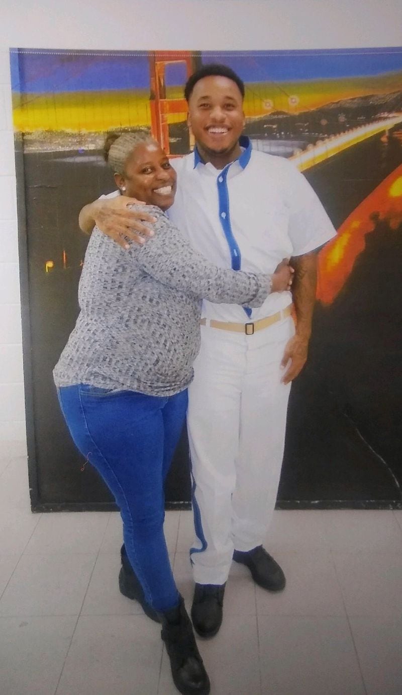 An incarcerated Marcus Battle is hugged by his mother, Sandra Reese, in a photo circa 2018. Reese says that Battle, now nearly 30 years old, has grown up while in prison. "He became a man that I couldn’t help him become,” she says. (Contributed)