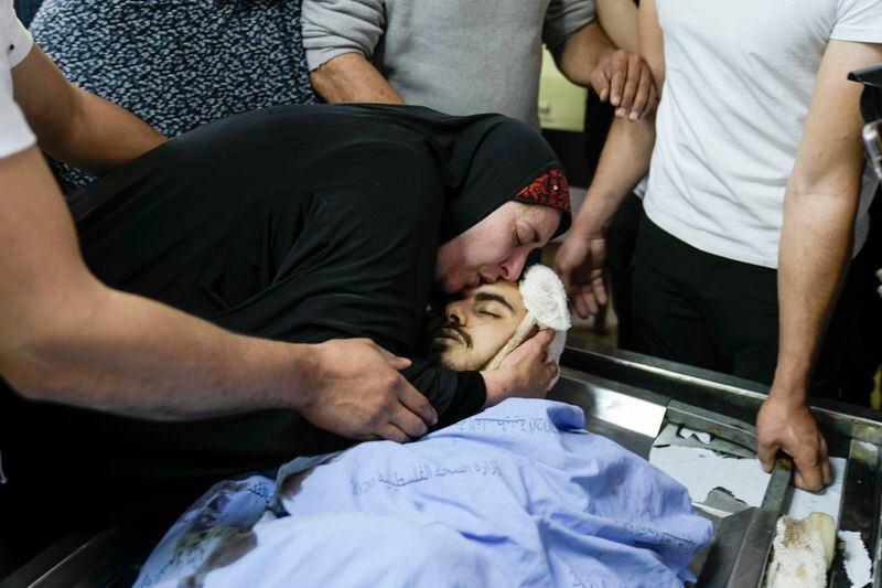 A Palestinian woman kisses Yazan Shtayyeh,17, killed in an Israeli military raid, just befor his funeral in West Bank village of Salem, Near the Palestinian town of Nablus, Monday, April 15, 2024. (AP Photo/Majdi Mohammed)