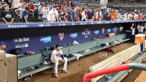 The last to leave the field Monday night, Braves infielder Johan Camargo sits in the dugout alone, contemplating the sudden end of the season. (Curtis Compton/Atlanta Journal-Constitution/TNS)