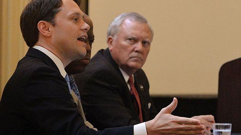Gov. Nathan Deal shoots a glance at Democrat Jason Carter during a Monday event hosted by the Professional Association of Georgia Educators. Kent D. Johnson, kdjohnson@ajc.com