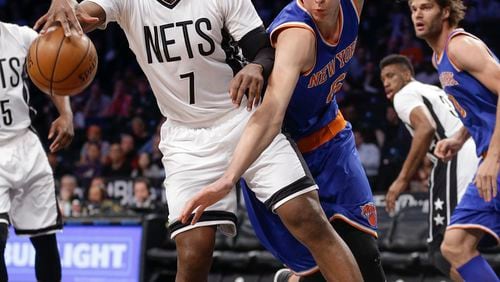 Brooklyn Nets forward Joe Johnson (7) pulls a rebound away from New York Knicks forward Kristaps Porzingis (6) during the first quarter of an NBA basketball game Friday, Feb. 19, 2016, in New York. (AP Photo/Julie Jacobson)