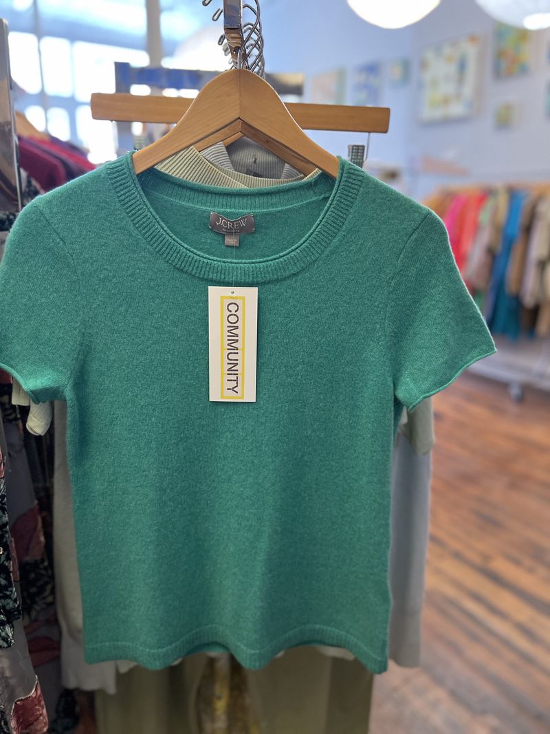 A thrifted T-shirt sweater is resold in Community, a retailer in downtown Athens with a sustainable mission. (Photo Courtesy of Asya McDonald)