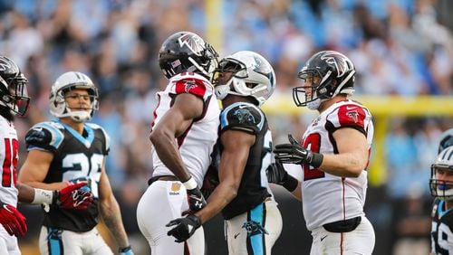 Carolina Panthers cornerback Josh Norman (24) and Atlanta Falcons wide receiver Julio Jones (11) exchange words after a play during an NFL football game at Bank of America Stadium in Charlotte, N.C. on Sunday, Dec. 13, 2015. (Chris Keane/AP Images for Panini)