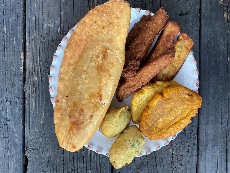 An assortment of fried bites from Jojo Fritay in Kennesaw includes pate kode with chicken, akra, sweet potato, plantains and marinad. Wendell Brock for The AJC