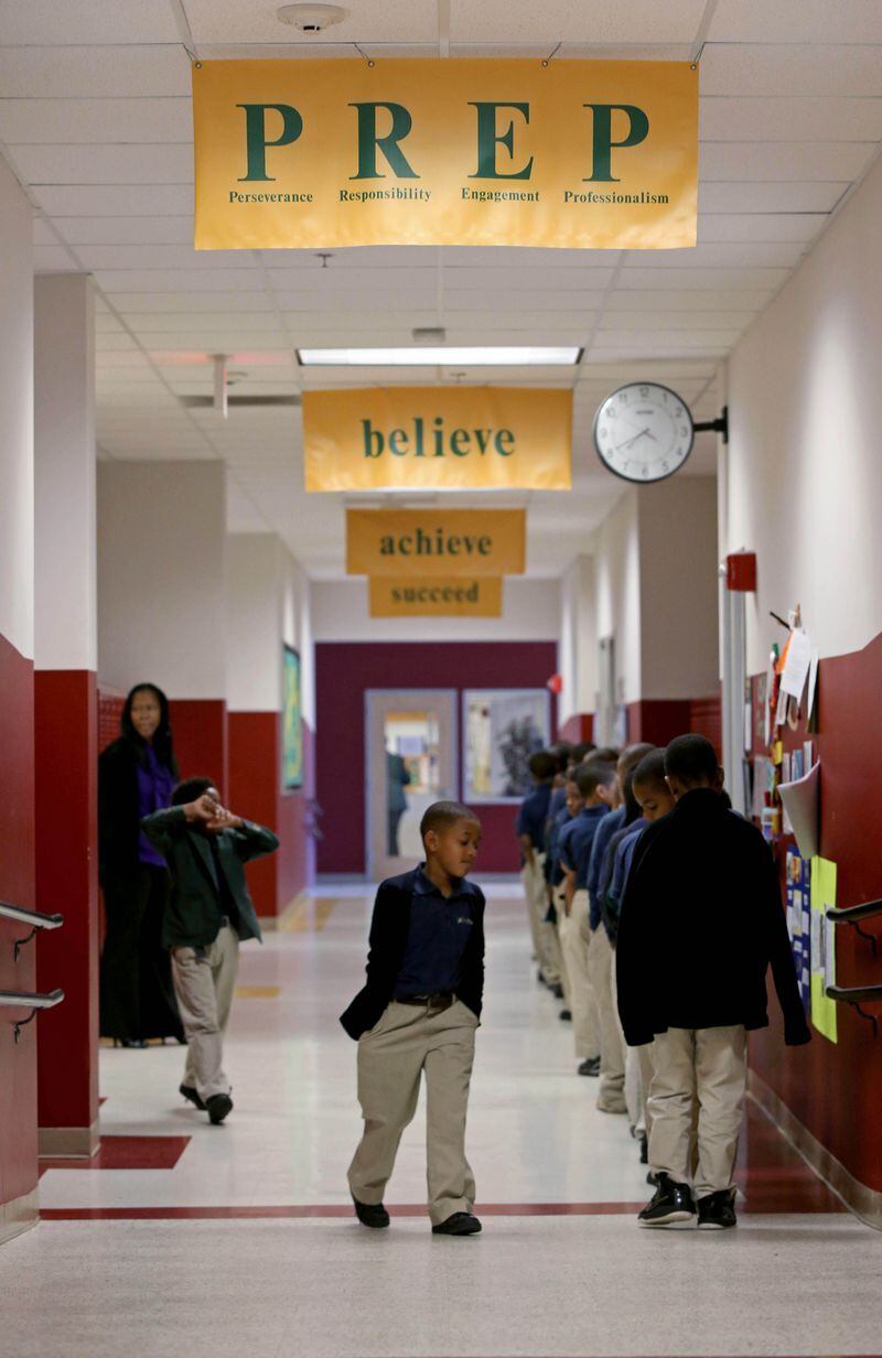Third grade boys walk in the hallway of Ivy Prep at Kirkwood. The charter school network is closing its high schools to concentrate on its elementary and middle school campuses. PHOTO / JASON GETZ