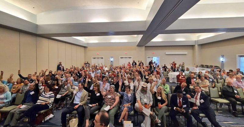 Newcomers to Georgia Republican meetings raise their hands during the 1st District GOP convention earlier this month.