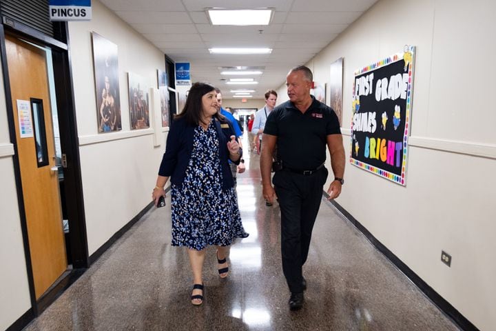 Compton Elementary School Principal Beth Lair walks the halls with Superintendent Chris Ragsdale on the first day of class Tuesday, Aug. 1, 2023, in Powder Springs.   (Ben Gray / Ben@BenGray.com)