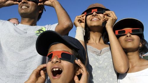 People observe a 2012 solar eclipse in Chico, California.
