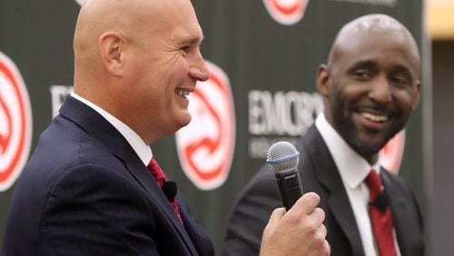 The Atlanta Hawks general manager Travis Schlenk introduces Lloyd Pierce as the 13th full-time coach in the Atlanta history of the NBA basketball franchise on Monday, May 14, 2018, in Atlanta. Pierce joins the Hawks after spending the past five seasons as an assistant coach with the 76ers. He also spent time with the Cavaliers, Warriors and Grizzlies organizations.   Curtis Compton/ccompton@ajc.com