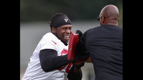 <Atlanta Falcons defensive end Takkarist McKinley (98) works with assistant defensive line coach Travis Jones during an NFL football practice Wednesday, May 30, 2018, in Flowery Branch, Ga. (AP Photo/John Bazemore)