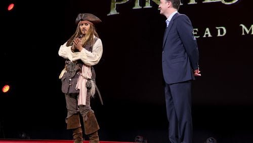 ANAHEIM, CA - AUGUST 15: Actor Johnny Depp, dressed as Captain Jack Sparrow, of PIRATES OF THE CARIBBEAN: DEAD MEN TELL NO TALES (L) and President of Walt Disney Studios Motion Picture Production Sean Bailey took part today in "Worlds, Galaxies, and Universes: Live Action at The Walt Disney Studios" presentation at Disney's D23 EXPO 2015 in Anaheim, Calif. (Photo by Jesse Grant/Getty Images for Disney)