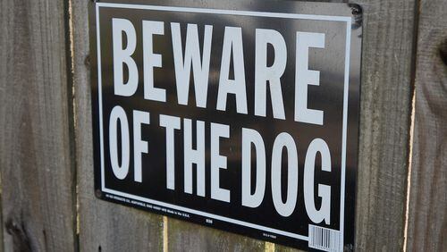Stock photo of a "Beware of the Dog" sign.
