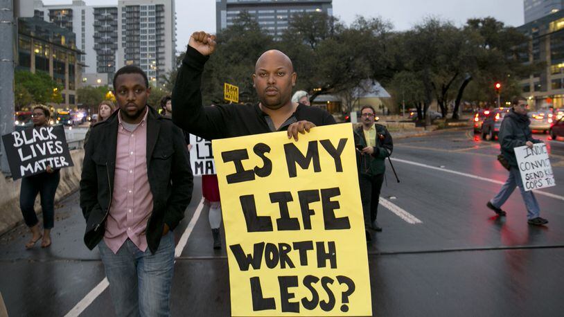 Chas Moore, left, and Ashton P. Woods, march with members of Black Lives Matter from City Hall to the Town Lake Center on Thursday March 10, 2016, to protest the shooting of David Joseph. JAY JANNER / AMERICAN-STATESMAN