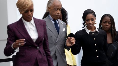 The Rev. Al Sharpton leads Fearless Fund CEO Arian Simone from the federal courthouse in Atlanta on Tuesday, Sept. 26, 2023. (Ben Gray / Ben@BenGray.com)