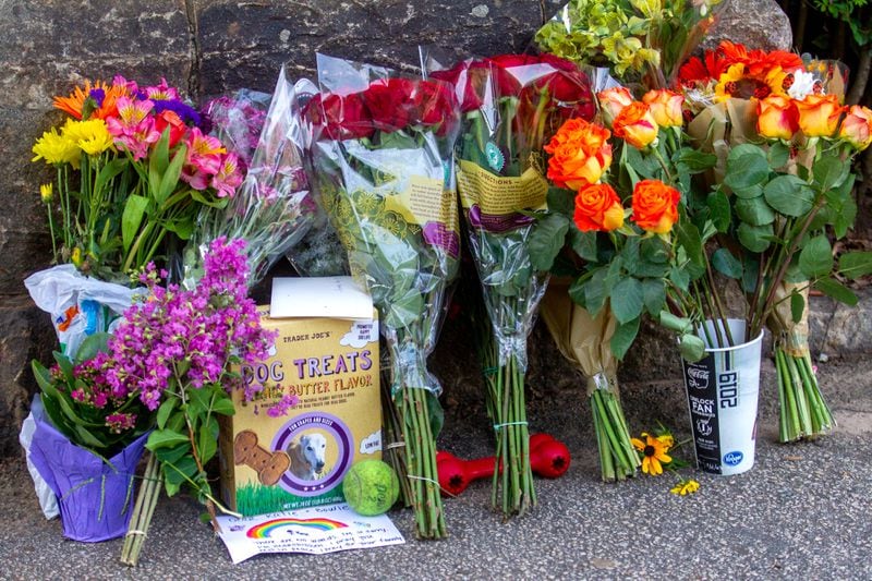 Flowers and dog treats are left near the location where stabbing victim Katherine Janness' body was found in Piedmont Park, according to Atlanta police. STEVE SCHAEFER FOR THE ATLANTA JOURNAL-CONSTITUTION
