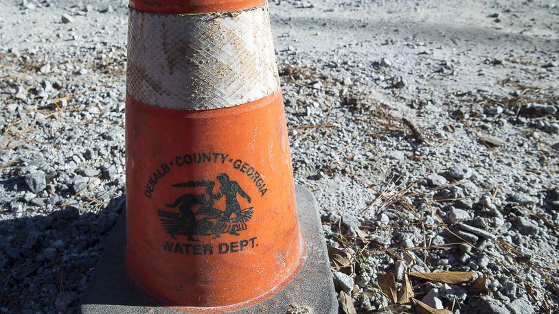 A DeKalb County Department of Watershed Management traffic cone is placed along the construction site where a water issue caused a brief outage on Mt. Olive Drive in Decatur on Jan. 11, 2019. (ALYSSA POINTER/ALYSSA.POINTER@AJC.COM)