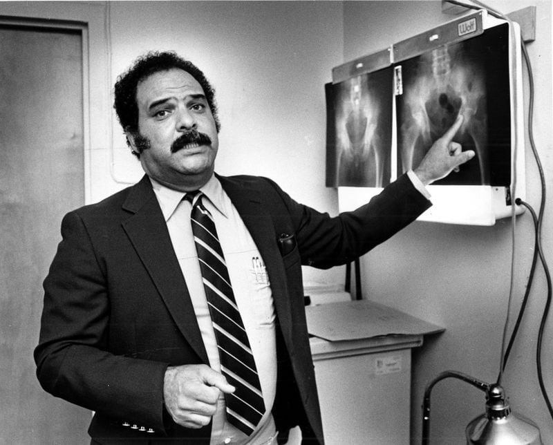 In 1963, the university admitted its first Black medical student, Hamilton E. Holmes. Two years earlier, in 1961 Holmes was one of the first two black students to attend the University of Georgia. Here he is in his office with X-rays in August 1983. File photo.