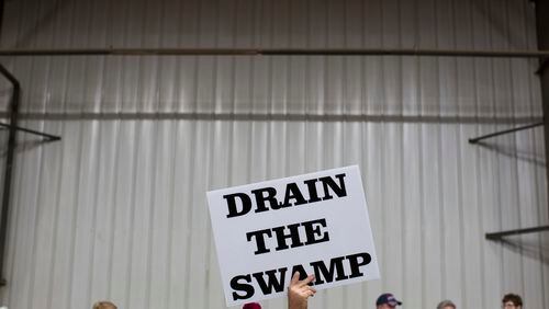 FILE - In this Oct. 27, 2016, file photo, supporters of then-Republican presidential candidate Donald Trump hold signs during a campaign rally in Springfield, Ohio. President-elect Donald Trump’s campaign promise to “drain the swamp” of Washington might make it difficult for him to fill all the jobs in his administration. (AP Photo/ Evan Vucci, file)