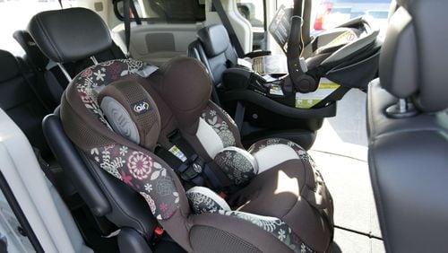 Child safety seats are installed in a van at the opening of the Dorel Technical Center for Child Safety in Columbus, Indiana, on Sept. 2, 2010.