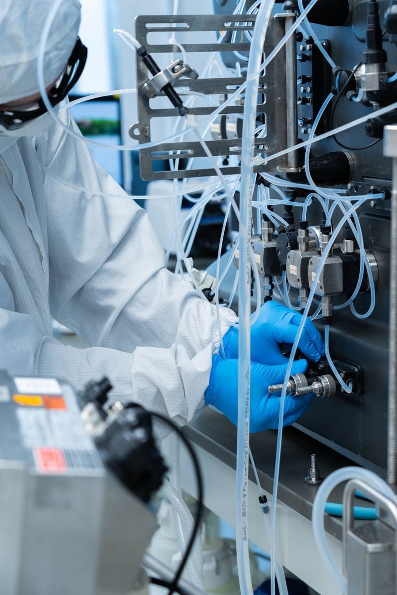 A Takeda scientist sets up a chromatography system (a step in the process of separating antibodies from plasma) to use for the manufacturing process of a hyperimmune globulin for COVID-19.