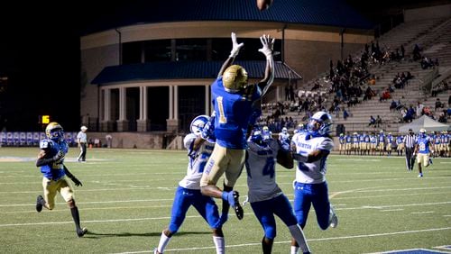 McEachern wide receiver Kaleb Webb (1) catches a pass over Newton’s defense to score a touchdown in the second half of play at McEachern High School Friday, Sept. 17, 2021. (Daniel Varnado/For the AJC)