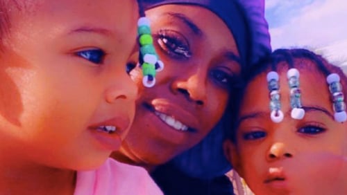 Queene Roux (center) and one of her children were killed in a crash on I-75, according to her family.