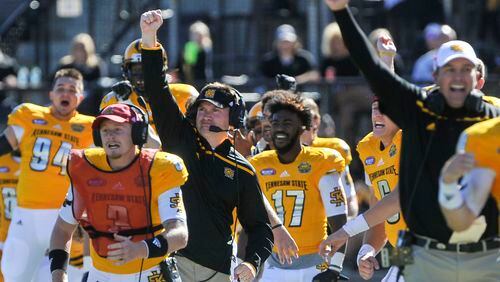 Kennesaw State head coach Brian Bohannon, third from left, reacts with the rest of the sidelines after taking possession of the ball after a turnover on downs during the second half of an NCAA college football game, Saturday, Oct. 17, 2015, in Kennesaw, Ga. Knees State won 12-7. (Photo/John Amis)
