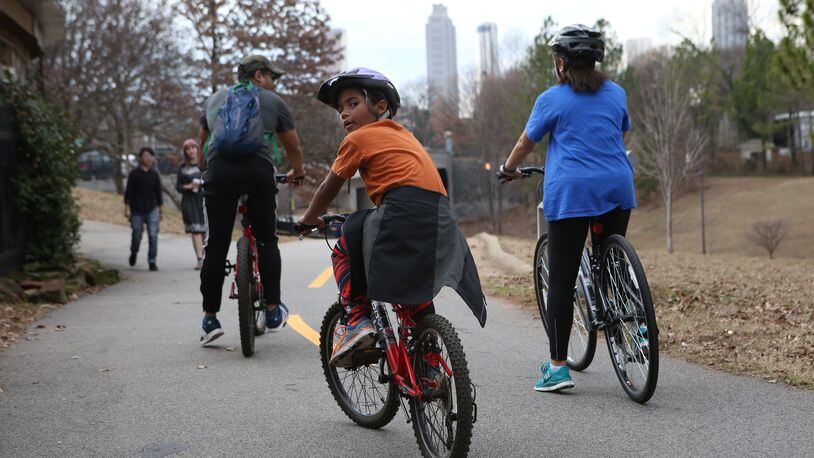 January 14, 2017, Atlanta - Benjamin Blackburn, 8, looks back as his father Ben Blackburn, 45, and sister Lindsay Blackburn, 15, ride off on the Beltline loop in Atlanta, Georgia, on Saturday, January 14, 2017. While president-elect Trump called the fifth district “horrible”, Ben Blackburn has been taking his kids to the Beltline for nearly four years and has always felt safe. (HENRY TAYLOR / HENRY.TAYLOR@AJC.COM)