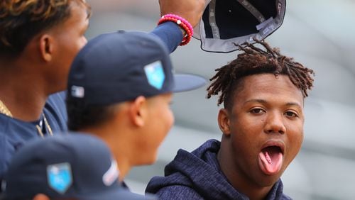 Braves outfielder Cristian Pache (left) clowns with Ronald Acuna  (right) grabbing his hat before Tuesday night’s Braves vs. Future Stars exhibition game at SunTrust Park. (Curtis Compton/ccompton@ajc.com)