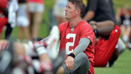 Falcons QB Matt Ryan knows how to tackle. Here he is as he stretches during the minicamp. Atlanta Falcons players workout during the second day of mini-camp at the team's facilities in Flowery Branch, Wednesday, June 18, 2014. KENT D. JOHNSON/KDJOHNSON@AJC.COM