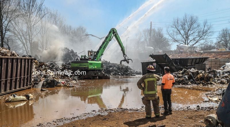 Atlanta fire Battalion Chief Greg Gray said a crane operator was removing debris from the scrapyard and crews were wetting the pieces as they went.