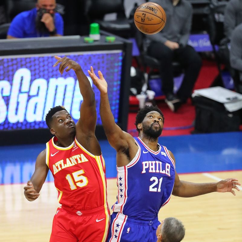 Hawks center Clint Capela and Philadelphia 76ers center Joel Embiid take the opening tip of Game 2 of the Eastern Conference semifinals Tuesday, June 8, 2021, in Philadelphia. (Curtis Compton / Curtis.Compton@ajc.com)