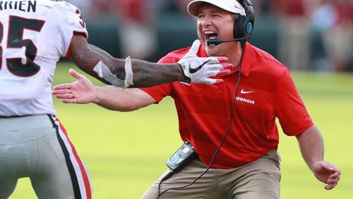 Georgia head coach Kirby Smart gives running back Brian Herrien five after he went over the top of South Carolina defenders for a touchdown and a 41-10 lead during the third quarter Saturday.