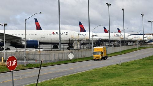 March 21, 2020 Atlanta - Several Delta Air Lines planes parked near the airline's headquarters at Hartsfield-Jackson Atlanta International Airport on Saturday, March 21, 2020.  (Hyosub Shin / Hyosub.Shin@ajc.com)