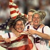 Joy Fawcett (left) and Carin Gabarra (right) run around Sanford Stadium in Athens with an American flag after their historic 2-1 gold medal win over China Thursday, Aug. 1, 1996, during the 1996 Summer Olympic Games. (David Tulis/AJC)