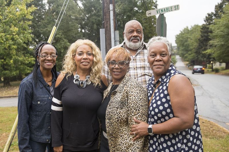 Rachel Barnes (from right), Maxie Outen (background), Lydia Bivins Shumake (third from right), Joyce Bivins Outen and Pamela Marshall (left), stand at the corner of Venable Street and Third Street in Stone Mountain. (Alyssa Pointer/Atlanta Journal Constitution)