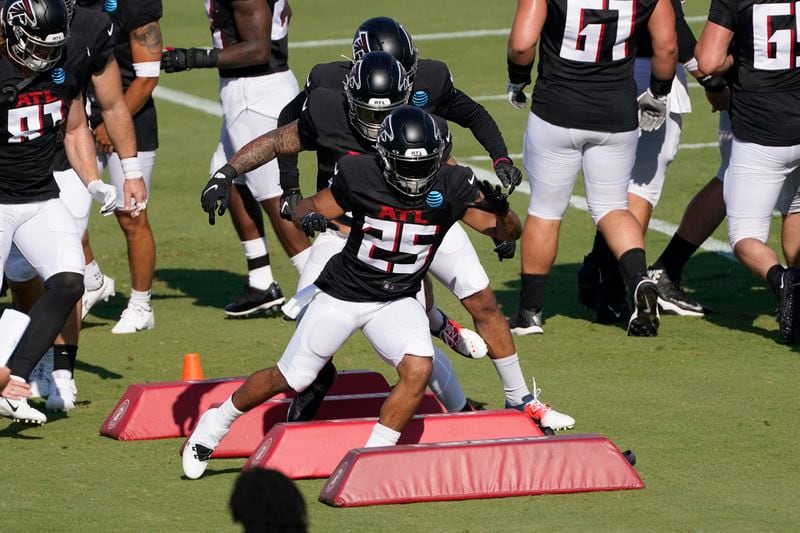 Falcons running back Ito Smith (25) runs a drill during practice Tuesday, Aug. 18, 2020, in Flowery Branch.