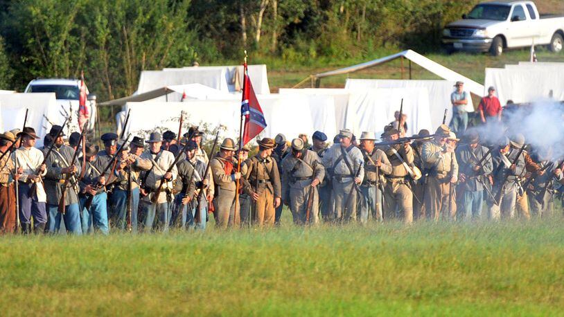 Confederate and Union re-enactors recreate the Battle of Utoy Creek during the Atlanta Campaign’s Battle of Atlanta re-enactment at the Nash Farm Battlefield in Hampton, Ga., on Sept. 19, 2014. KENT D. JOHNSON / KDJOHNSON@AJC.COM
