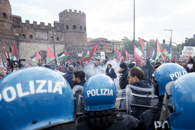 People hold Palestinians flags as they march during the solemn Liberation Day commemoration, in Rome, Thursday, April 25, 2024. Italy is marking its liberation from Nazi occupation and fascist rule amid a fresh media controversy over the legacy of Italian fascist complicity in the Holocaust and World War II-era crimes. Premier Giorgia Meloni, whose Brothers of Italy party traces its roots to the neo-fascist movement that emerged after the fall of dictator Benito Mussolini, joined the Italian president at the tomb of the unknown soldier in Rome. (Cecilia Fabiano/LaPresse via AP)