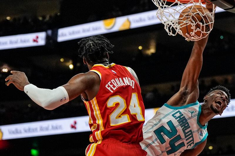 Charlotte Hornets forward Brandon Miller (24) dunks against Atlanta Hawks forward Bruno Fernando (24) during the first half of an NBA basketball game, Wednesday, April 10, 2024, in Atlanta. (AP Photo/Mike Stewart)