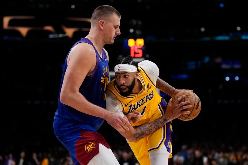 Denver Nuggets center Nikola Jokic (15) defends against Los Angeles Lakers forward Anthony Davis (3) during the second half of Game 3 of an NBA basketball first-round playoff series in Los Angeles, Thursday, April 25, 2024. (AP Photo/Ashley Landis)