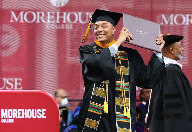 Dimitri Foster celebrates receiving his degree as he walks off the stage during the Morehouse College 138th Commencement Ceremony on Sunday, May 15, 2022, in Atlanta. (Curtis Compton / Curtis.Compton@ajc.com)
