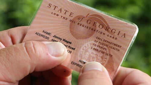 After battling for years to help treat his daughter, Sydney, with cannabis oil, J-Bo Wages finally holds his state of Georgia low-THC cannabis oil registration card. Curtis Compton / ccompton@ajc.com
