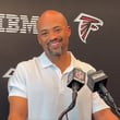 Falcons GM Terry Fontenot shares a playful exchange with the AJC's D. Orlando Ledbetter during Tuesday's media gathering.
