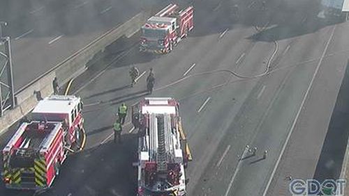 Cameras show fire trucks at the scene of a tractor-trailer fire on I-285 West.