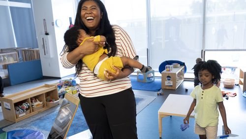 Rebecca Riley, who works as a marketing specialist for Mercedes-Benz Financial Services, picks up her children Sebastian, 3, and Ty, 7 months, from the on-site day care after finishing her work day in Sandy Springs on Thursday, April 11, 2024.   (Ben Gray / Ben@BenGray.com)