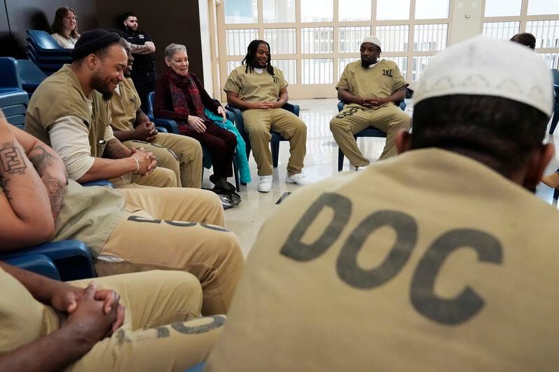 Detainees, DePaul students, DePaul staff, Helen Damon-Moore, third from right, and Sister Helen Prejean attend a book club at Department Of Corrections Division 11 in Chicago, Monday, April 22, 2024. DePaul students and detainees are currently reading Dead Man Walking and the author, anti death penalty advocate, Sister Helen Prejean attended to lead a discussion. (AP Photo/Nam Y. Huh)